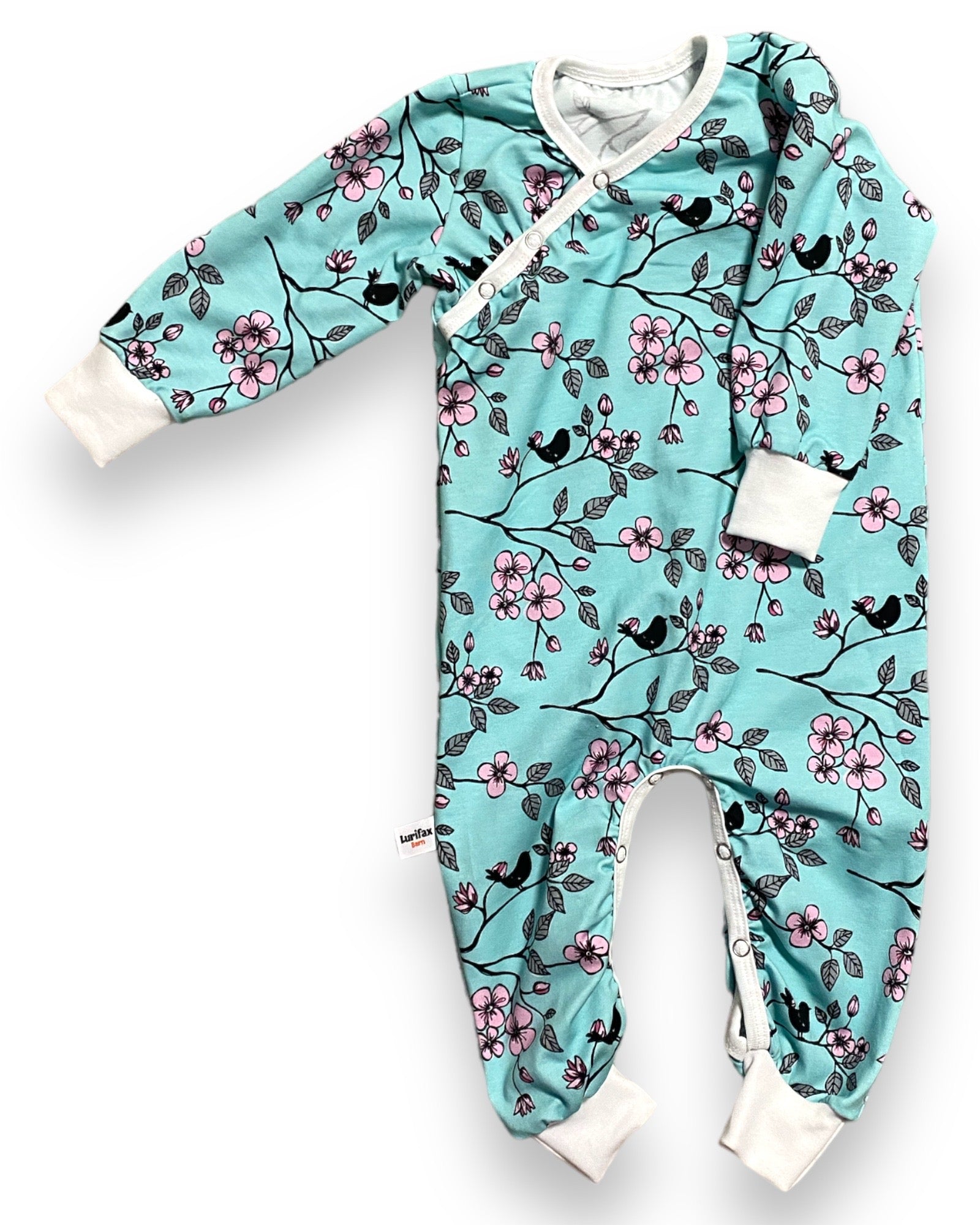 Sparkdräkt för baby i mint med blommor och fåglar, tryckknappar i grenen.
