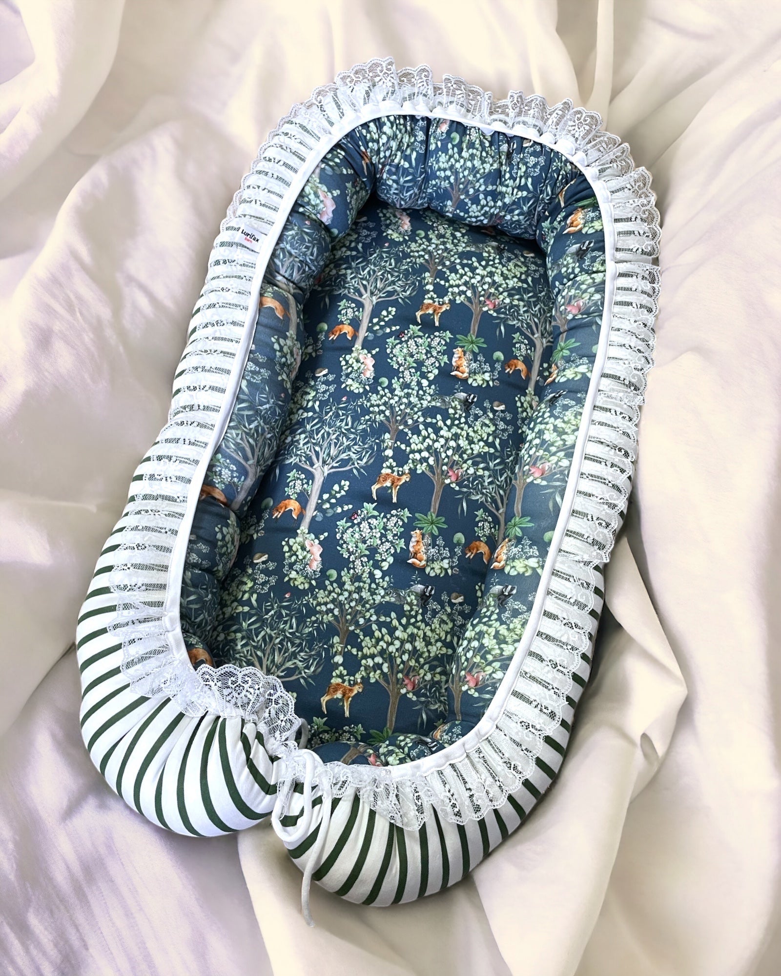Vändbart babynest i skogsvänner-motiv med stödjande sidor