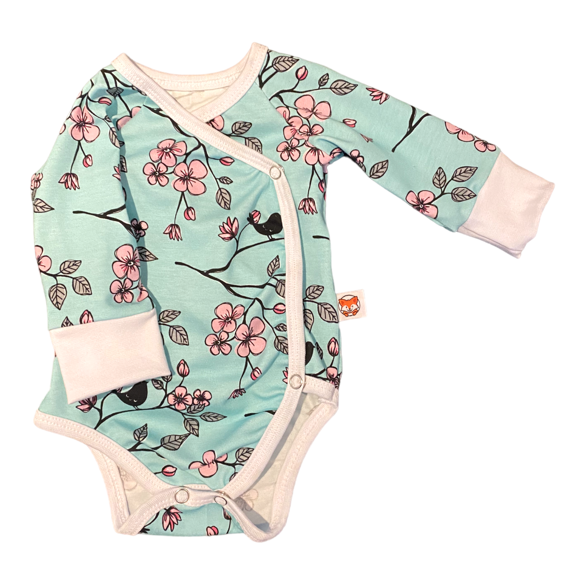 Omlottbody för baby i mint med blommor och fåglar, vitt kantband.